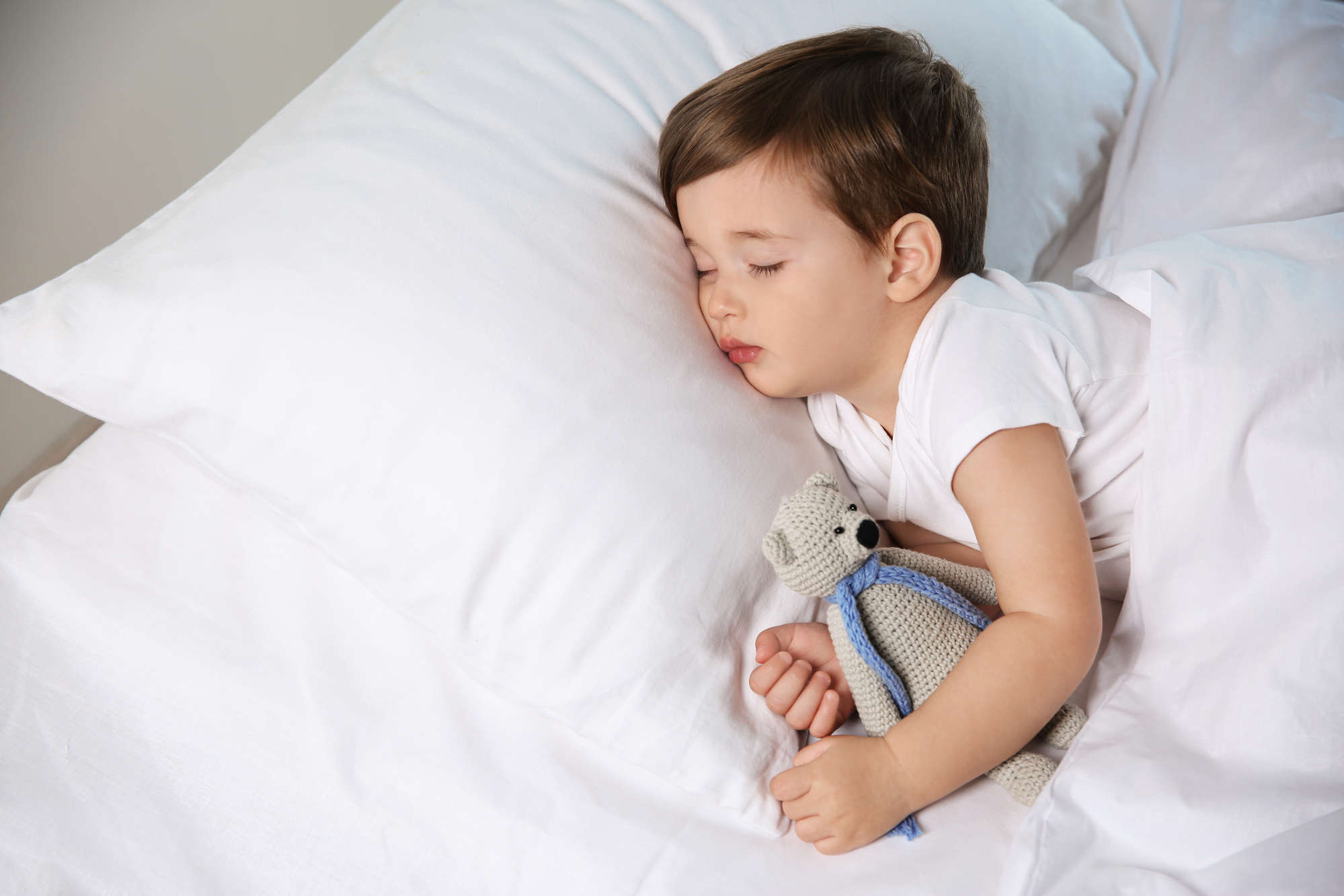 Cute little baby sleeping with toy at home. Bedtime